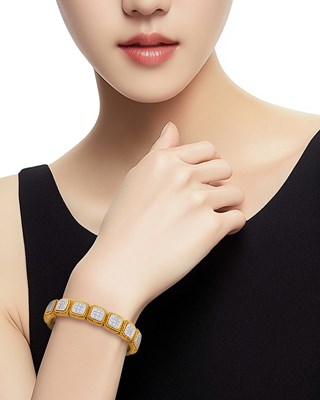 Lot 86 - Two-Color Gold and Diamond Bangle Bracelet