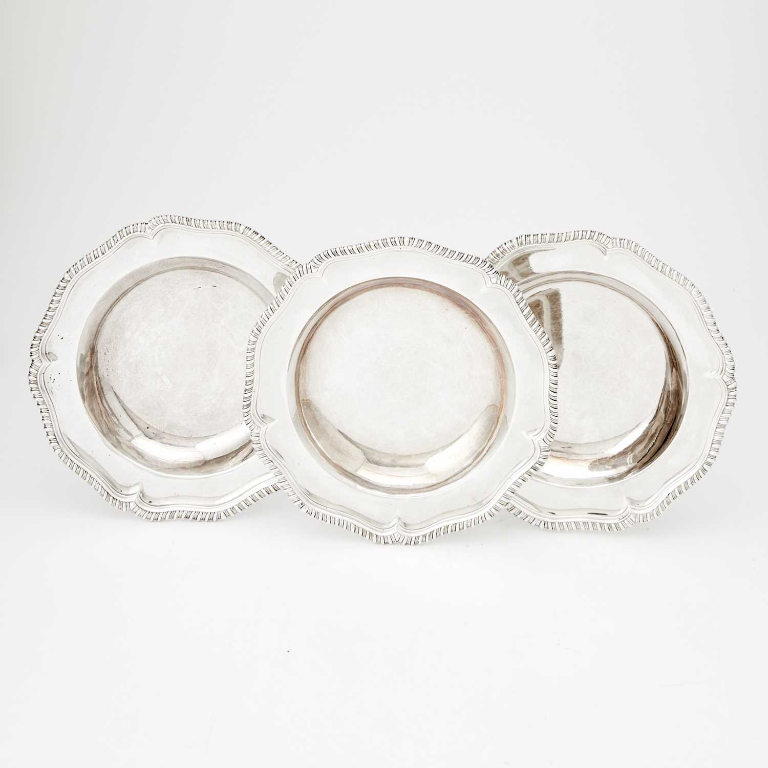 Lot 325 - Three George III Sterling Silver Soup Plates