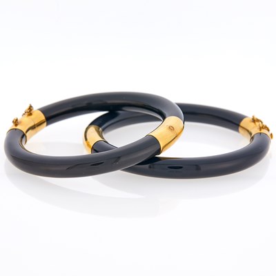 Lot 1021 - Pair of Black Onyx and Gold Bangle Bracelets