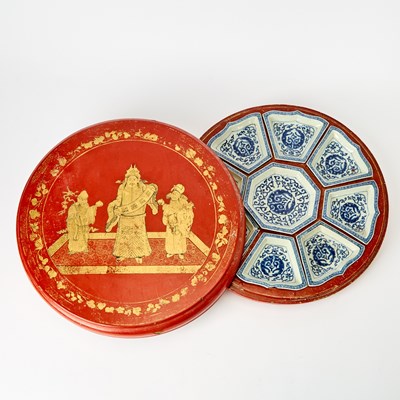 Lot 108 - A Chinese Gilt decorated Red Lacquer Box with Porcelain Sweetmeat Dishes