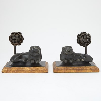 Lot 458 - Pair of Ebonized and Parcel-Gilt Carved Wood and Iron Lions