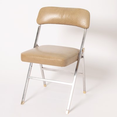 Lot 229 - Karl Springer Polished Chromed Metal, Gilt-Metal, and Ostrich Print Naugahyde Folding Accent Chair