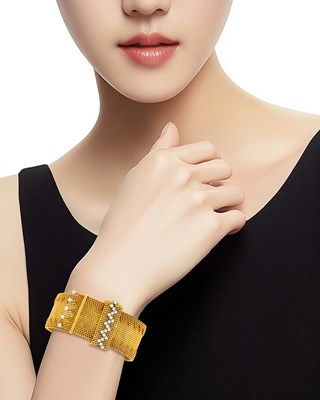 Lot 172 - Gubelin Wide Gold, Platinum and Diamond Mesh Slide Bracelet