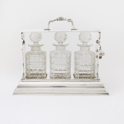 Lot 103 - Silver-Plated Tantalus with Three Glass Decanters