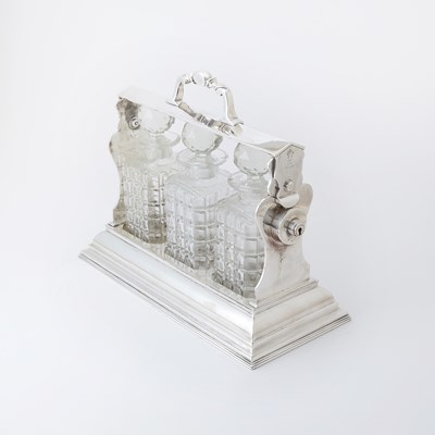 Lot 103 - Silver-Plated Tantalus with Three Glass Decanters