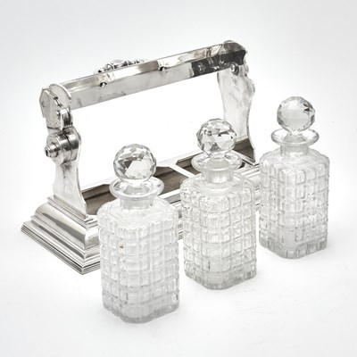 Lot 103 - Silver-Plated Tantalus with Three Glass Decanters