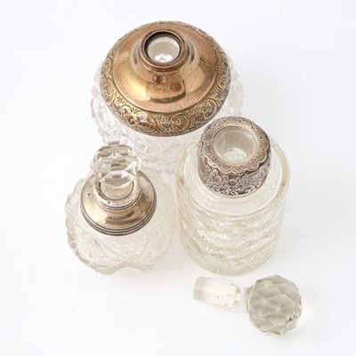 Lot 112 - Three Silver-Mounted Cut-Glass Stoppered Perfume Bottles on a Silver-Plated Glass-Bottom Tray