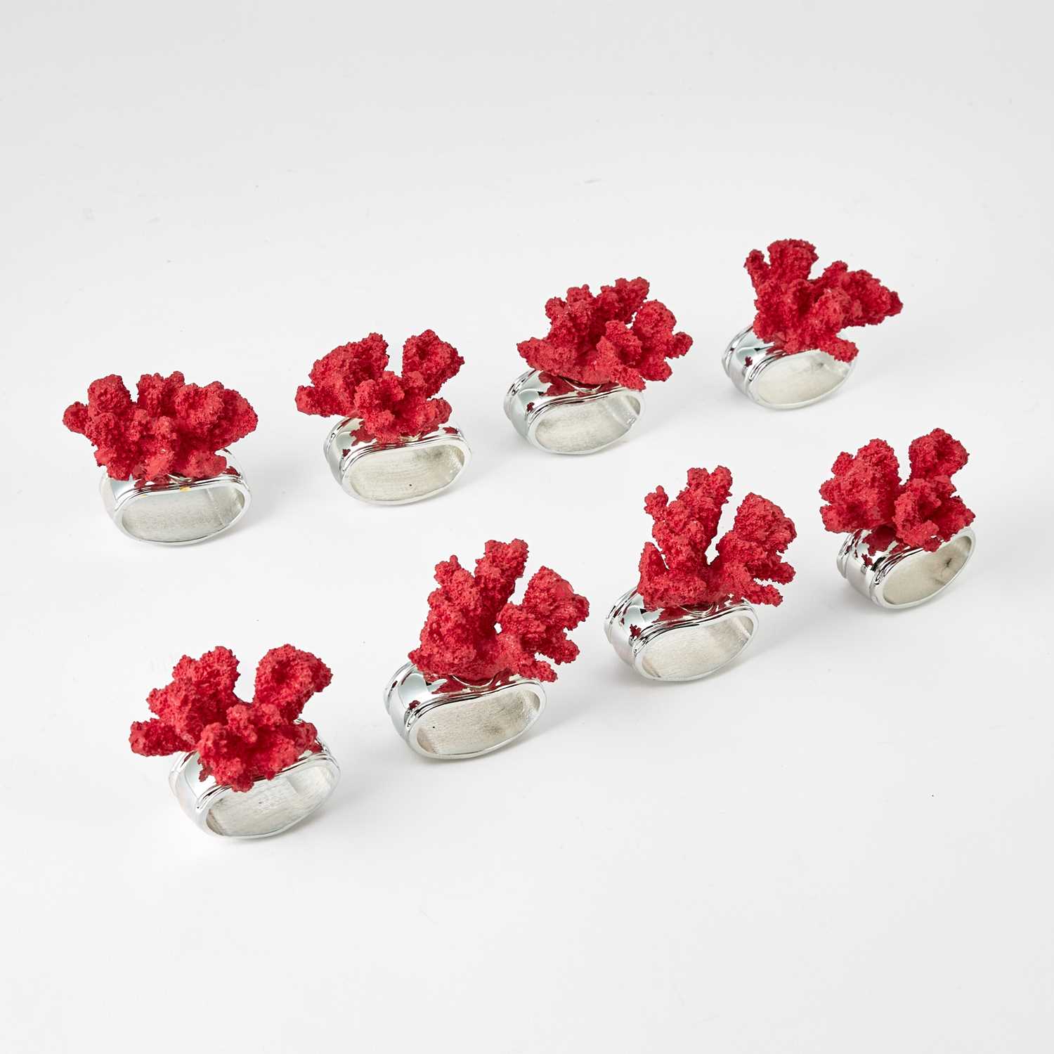 Lot 597 - Set of Eight Hans Turnwald Faux Coral and Silver Plated Napkin Rings
