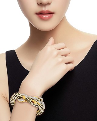 Lot 101 - David Webb Gold, Platinum, Black and White Enamel, Diamond and Cabochon Ruby Zebra Bracelet