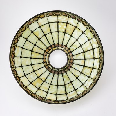 Lot 678 - Tiffany Studios Bronze and Leaded Glass ‘Colonial Faux-Jeweled Band’ Table Lamp