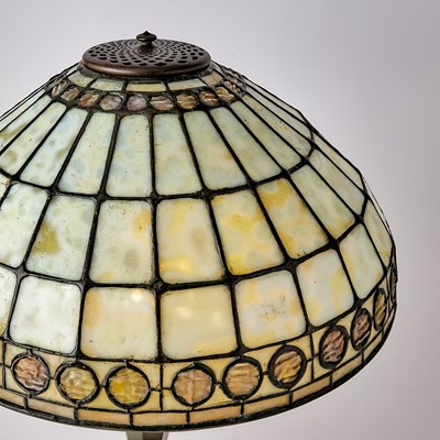 Lot 678 - Tiffany Studios Bronze and Leaded Glass ‘Colonial Faux-Jeweled Band’ Table Lamp