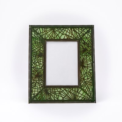 Lot 177 - Tiffany Studios Green Patinated Etched Metal and Favrile Glass Photograph Frame