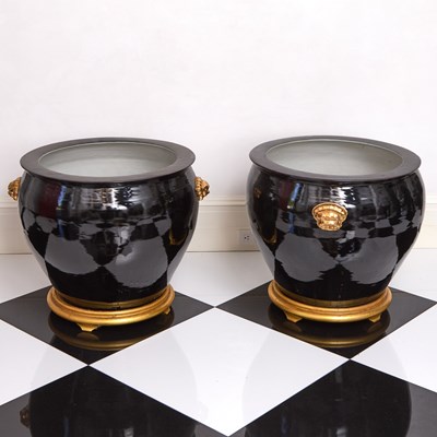 Lot 141 - Large Pair of Chinese Black Glazed Porcelain Planters with Gilt Lion's Masks on Giltwood Stands