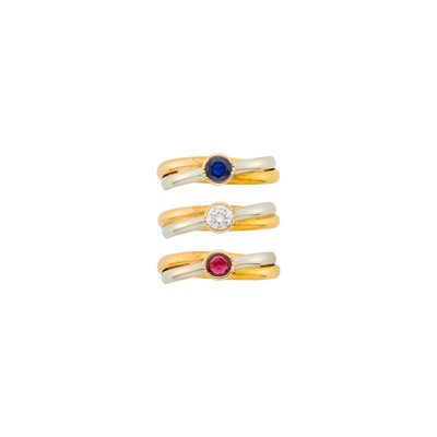 Lot 6 - Cartier Three Tricolor Gold, Ruby, Sapphire and Diamond 'Trinity' Band Rings, France