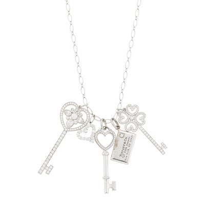 Lot 1134 - Tiffany & Co. Platinum, White Gold, Silver and Diamond Charm Necklace