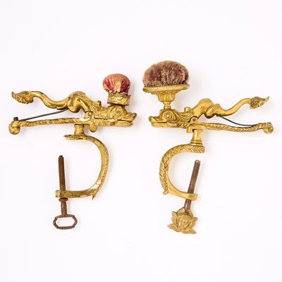 Lot 1236 - Two Gilt Brass Dolphin Sewing Clamps with Pin Cushions