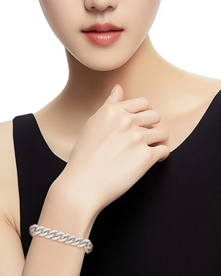 Lot 1047 - White Gold and Diamond Curb Link Bracelet
