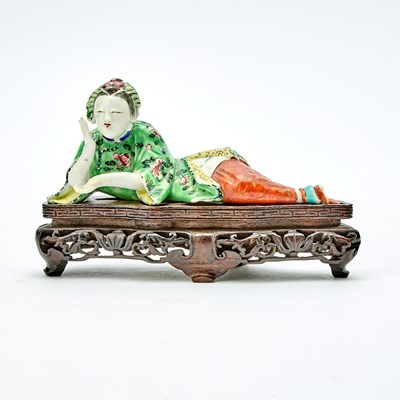 Lot 201 - A Chinese Enameled Porcelain Figure of a Reclining Lady
