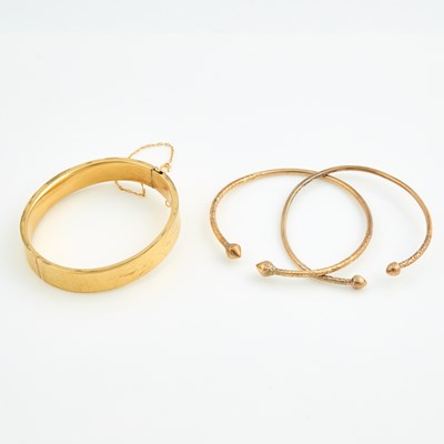 Lot 305 - Three Gold Rigid Bracelets, 10K 27 dwt., damaged