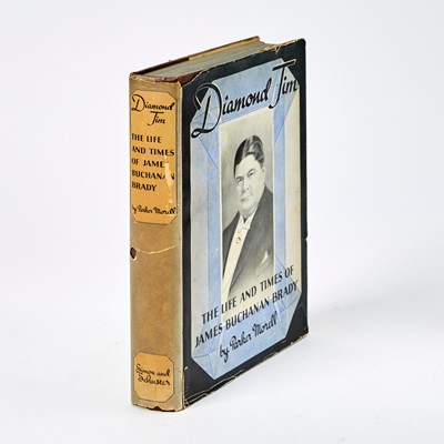 Lot 295 - A biography of Diamond Jim, the extravagant Gilded Age businessman, with a faux diamond inset to the cover