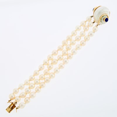 Lot 1145 - Seaman Schepps Triple Strand Baroque Cultured Pearl Bracelet with Shell, Gold and Lapis 'Turbo Shell' Clasp