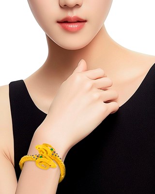Lot 21 - Zolatas Gold and Gem-Set Ram's Head Crossover Bangle Bracelet