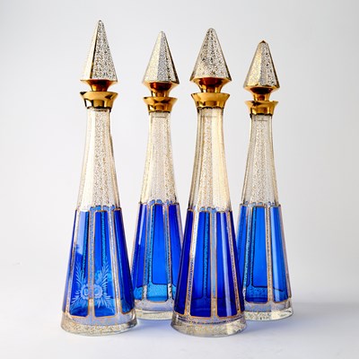 Lot 285 - Set of Four Bohemian Gilt and Blue Flashed Glass Liquor Bottle and Stoppers