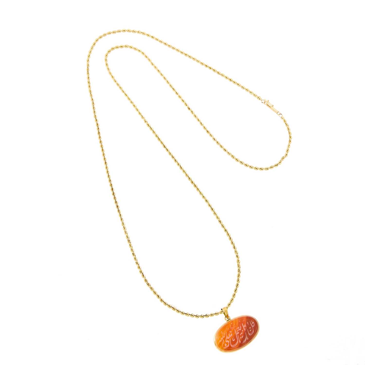 Lot 1036 - Gold and Carved Carnelian Pendant with Long Rope-Twist Gold Chain Necklace