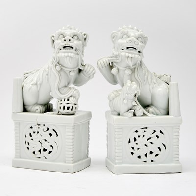 Lot 212 - A Pair of Chinese Blanc de Chine Porcelain Fu Dogs