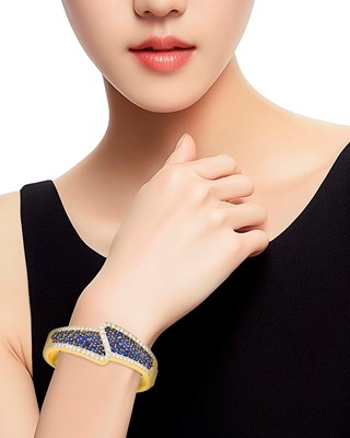 Lot 26 - Two-Color Gold, Sapphire and Diamond Bangle Bracelet