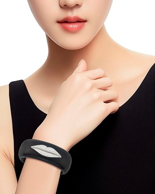 Lot 50 - Ebony, White Gold and Diamond 'Lips' Cuff Bangle Bracelet and Solange Azagury-Partridge Silver and Red Enamel 'Lips' Ring