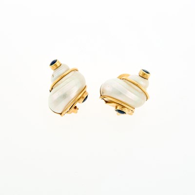 Lot 1146 - Seaman Schepps Pair of Gold, Shell and Cabochon Sapphire 'Turbo Shell' Earclips