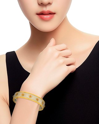 Lot 73 - Mario Buccellati Two-Color Gold and Ruby Bangle Bracelet