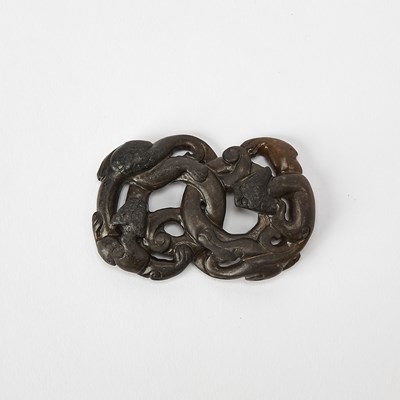 Lot 320 - A Chinese Black and Celadon Jade Dragon-Form Pendant