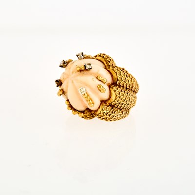 Lot 1070 - Gold, Carved Angel Skin Coral and Diamond Ring