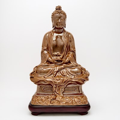 Lot 195 - A Chinese Cafe au Lait Glazed Porcelain Figure of Shakyamuni