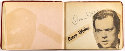 Lot 129 - Autograph album with Orson Welles, Rita Hayworth, Lauren Bacall, Gloria Swanson, Peter Lorre, and others