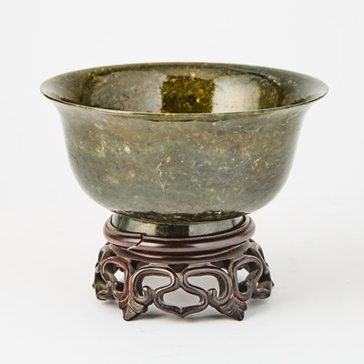 Lot 34 - A Chinese Spinach Jade Footed Bowl with a Wooden Stand