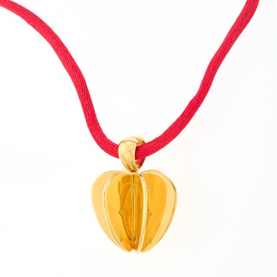 Lot 2004 - Cartier Gold Apple Pendant with Silk Cord