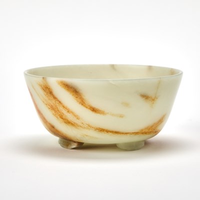 Lot 401 - A Chinese Russet and Pale Celadon Jade Footed Bowl