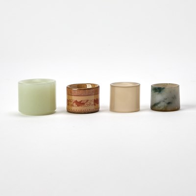 Lot 418 - Four Chinese Hardstone and Porcelain Thumb Rings