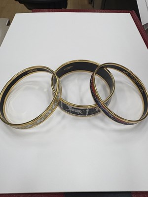 Lot 2083 - Hermès Three Gilt-Metal and Enamel Bangle Bracelets