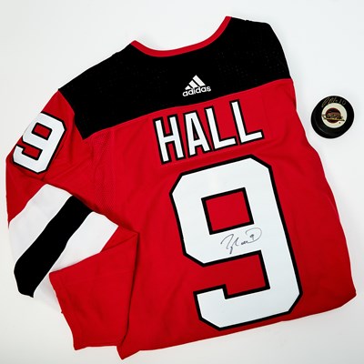 Lot 82 - NJ Devils Jersey signed by Taylor Hall, a puck signed by Pavel Bure, and two framed photographs signed by Henrik Lundqvist