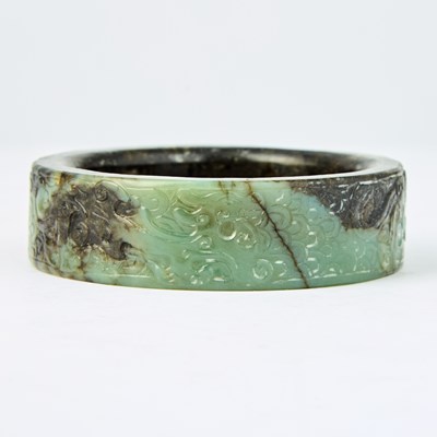 Lot 6 - A Chinese Archaistic Mottled Jade Bangle