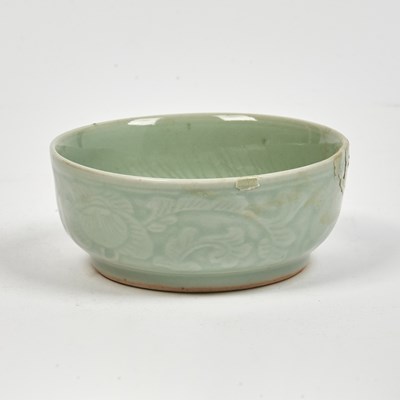 Lot 196 - A Chinese Celadon Glazed Porcelain Dish Molded with Flowers and a Fish Against Crashing Waves