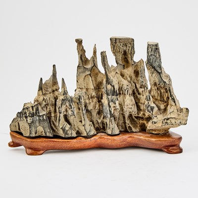 Lot 112 - A Chinese Horizontally-Oriented Scholar's Rock on a Wooden Stand