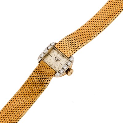 Lot 1141 - Universal Two-Color Gold and Diamond Wristwatch