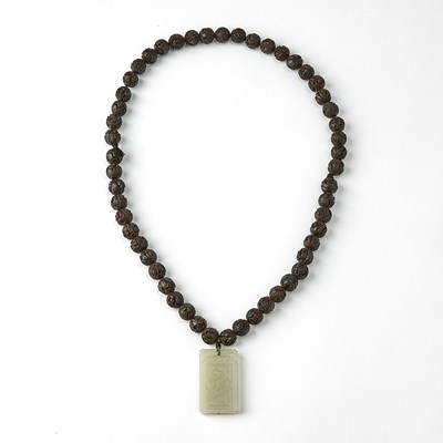 Lot 462 - A Chinese Carved Walnut Necklace with a White Jade Pendant
