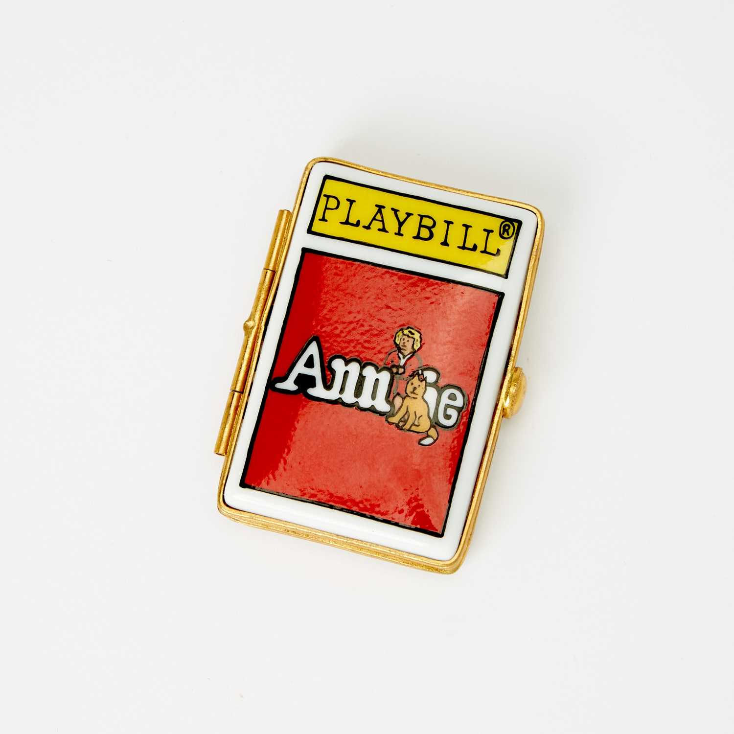 Lot 31 - A porcelain box in the shape of an Annie playbill