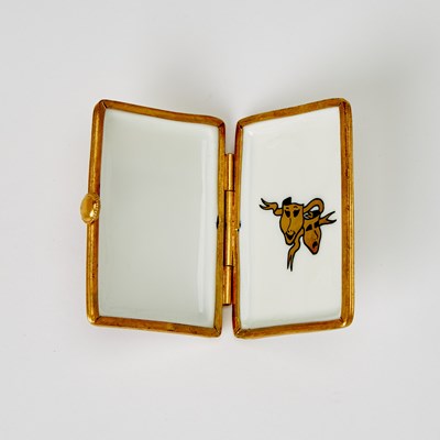 Lot 31 - A porcelain box in the shape of an Annie playbill